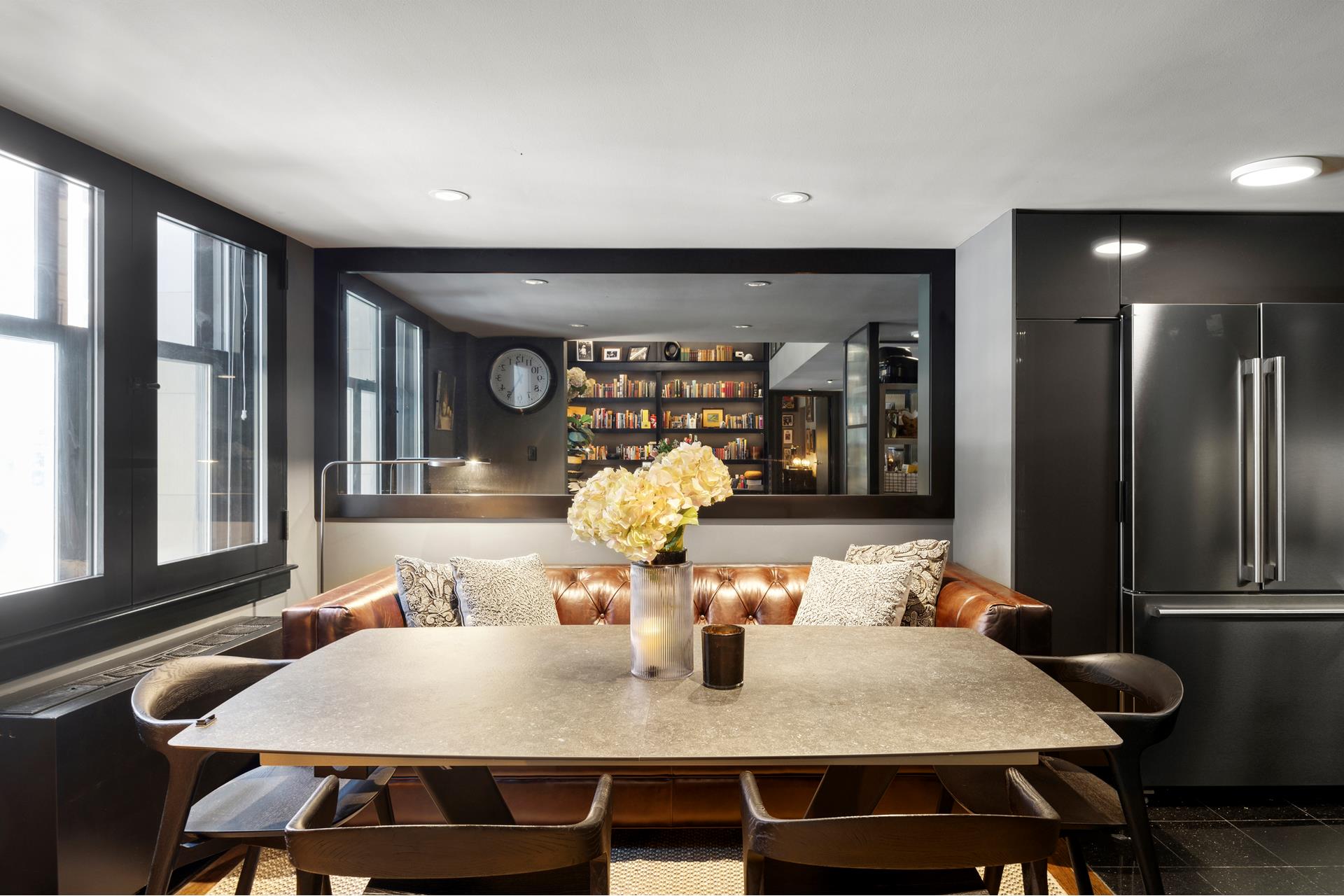 240 Centre Street, Unit 2K Manhattan, NY 10013 - Photo 4 of 10 a view of a dining room with furniture window and wooden floor