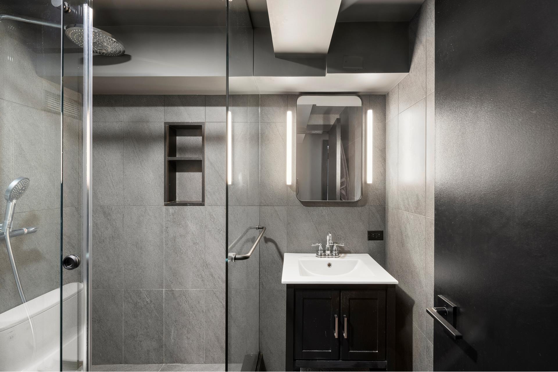 240 Centre Street, Unit 2K Manhattan, NY 10013 - Photo 8 of 10 a bathroom with a sink and mirror