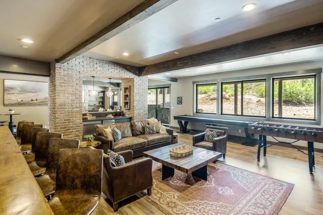 a living room with furniture a rug and a large window