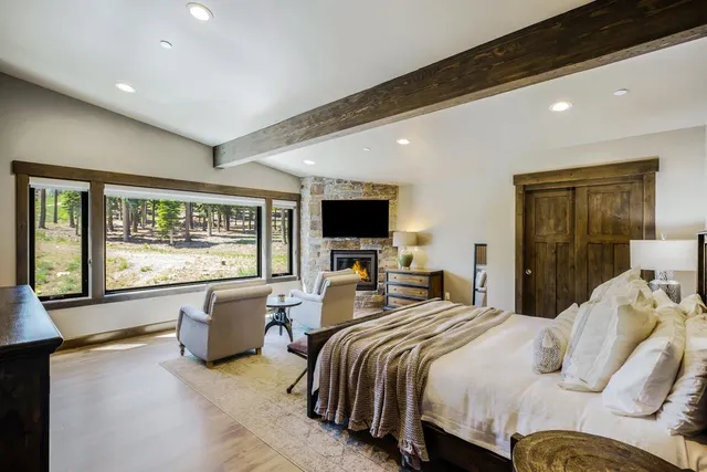 a bedroom with bed and large windows