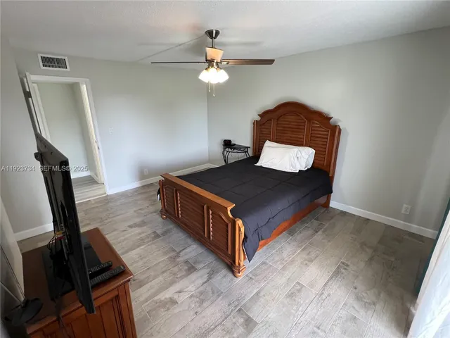 a living room with a bed furniture and a window