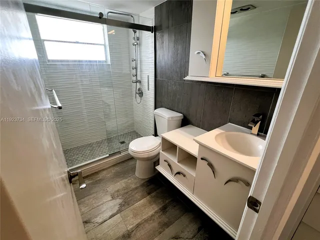 a bathroom with a toilet and a shower