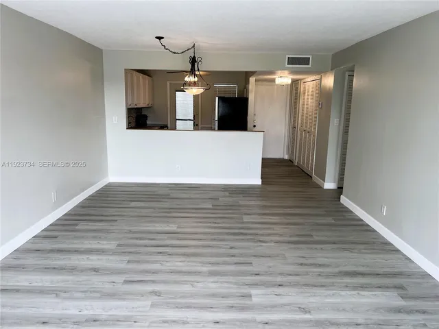 a view of a kitchen with a sink and wooden floor