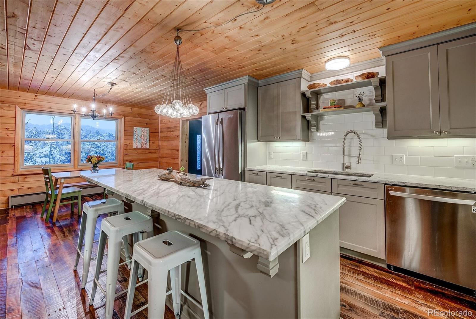 9055 Eagle Cliff Road Conifer, CO 80433 - Photo 12 of 39 a kitchen with granite countertop a sink a counter space appliances and cabinets