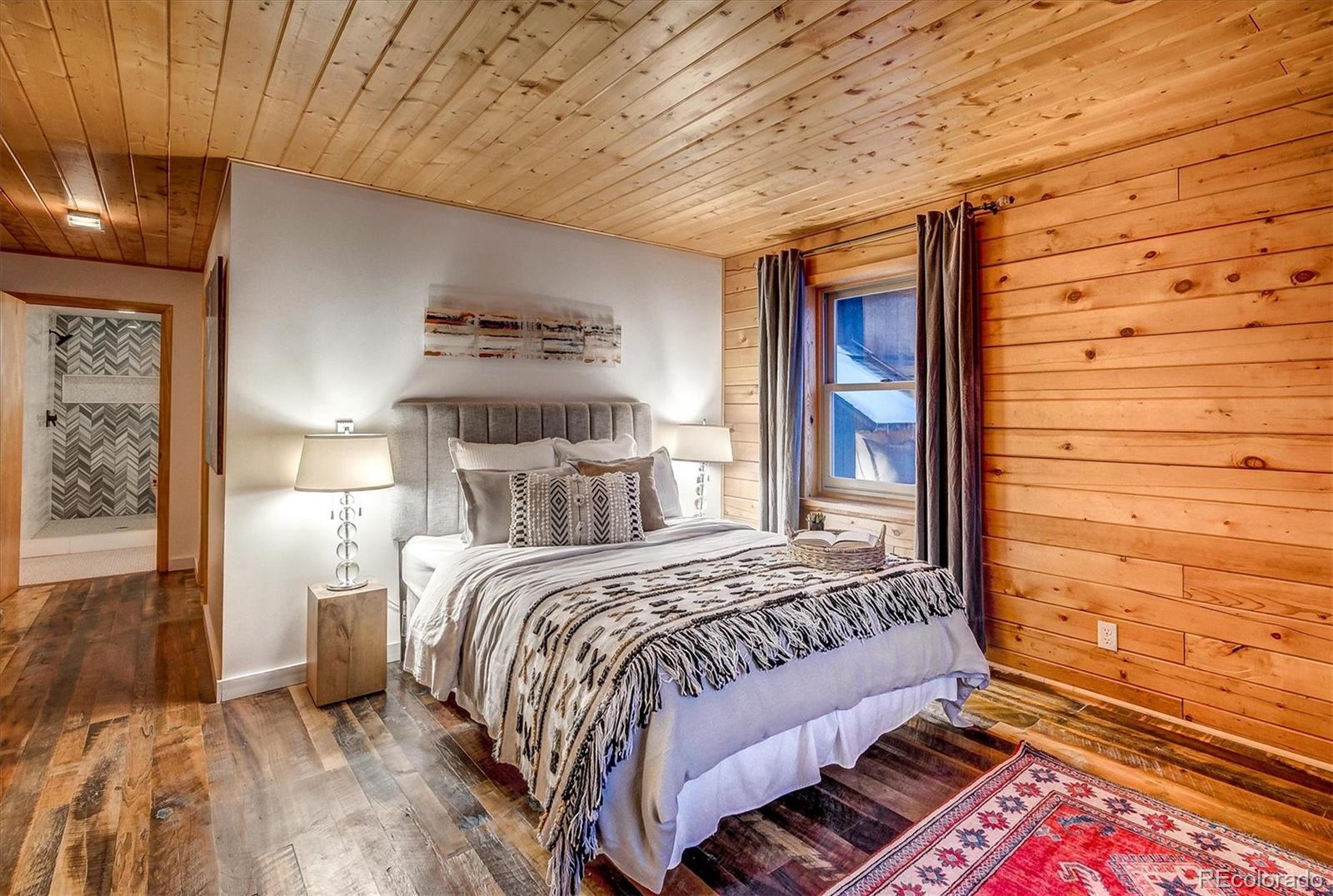 9055 Eagle Cliff Road Conifer, CO 80433 - Photo 16 of 39 a bedroom with a bed and a window