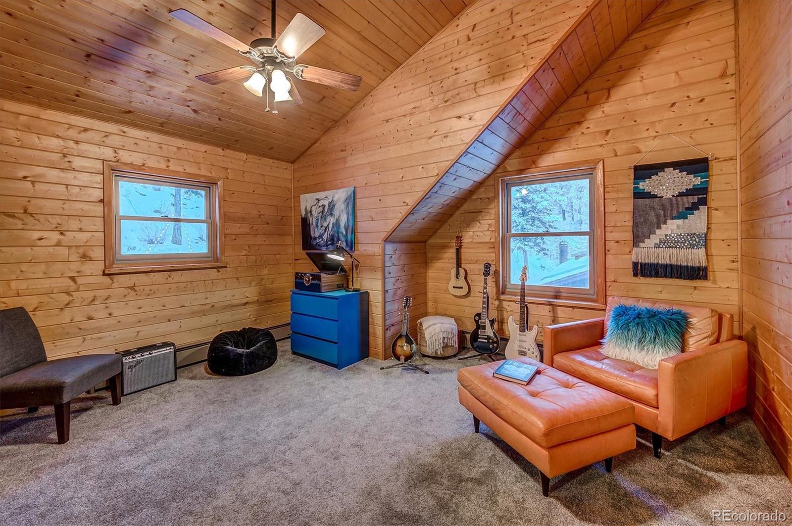 9055 Eagle Cliff Road Conifer, CO 80433 - Photo 23 of 39 a living room with furniture a ceiling fan and a window