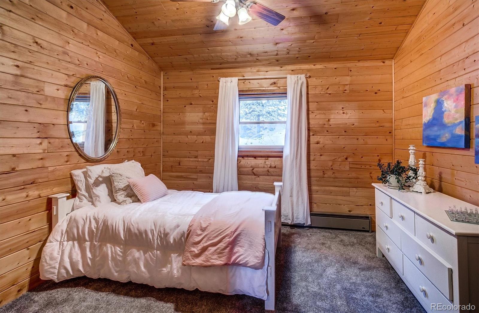 9055 Eagle Cliff Road Conifer, CO 80433 - Photo 24 of 39 a bedroom with a bed and a dresser