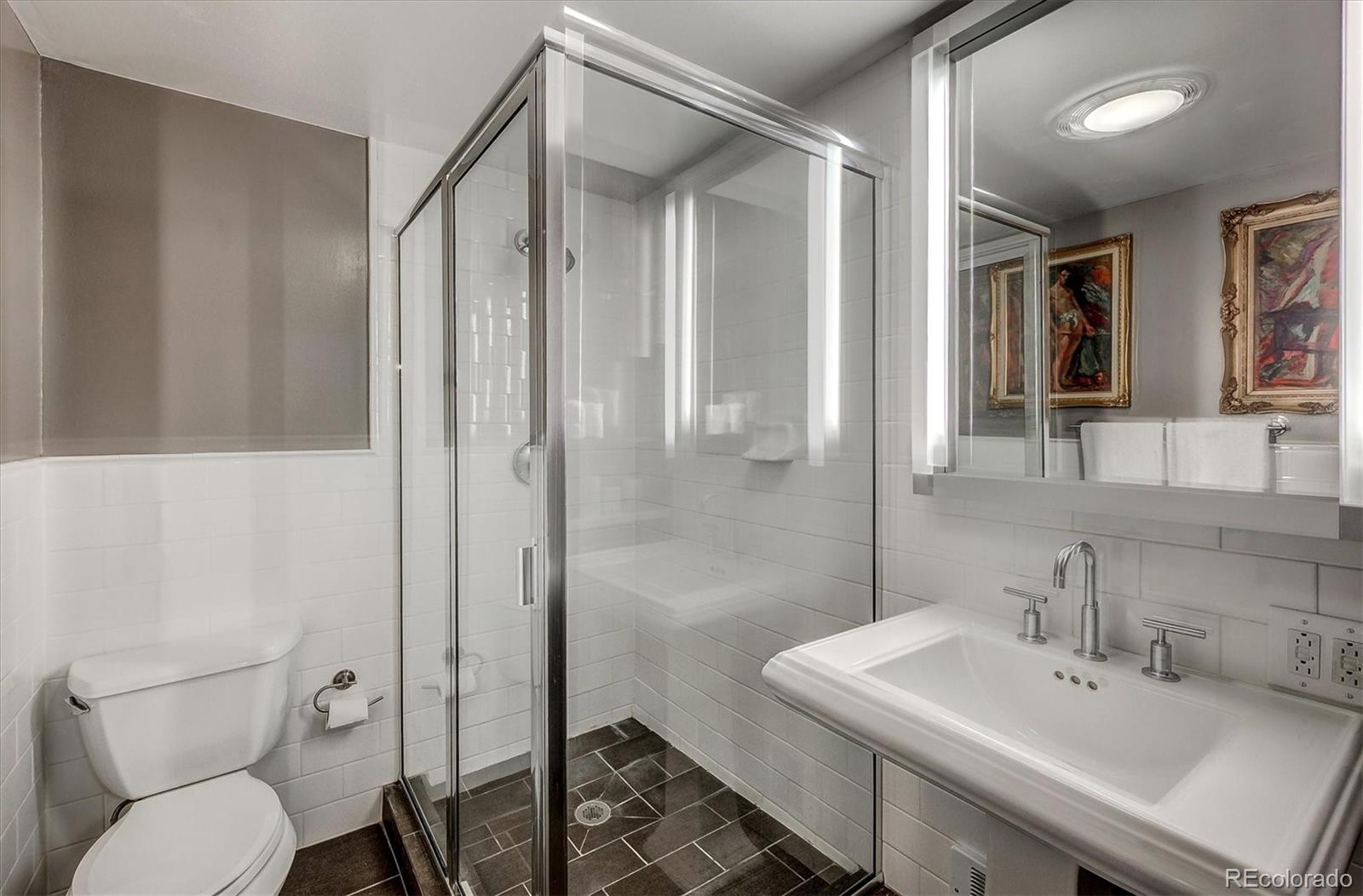 9055 Eagle Cliff Road Conifer, CO 80433 - Photo 31 of 39 a bathroom with a sink toilet and shower