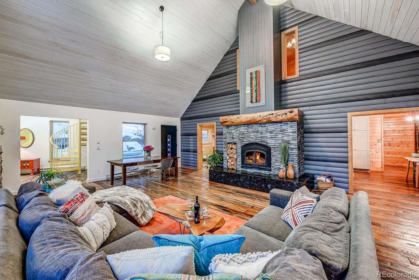 9055 Eagle Cliff Road Conifer, CO 80433 - Photo 4 of 39 a living room with furniture and a fireplace