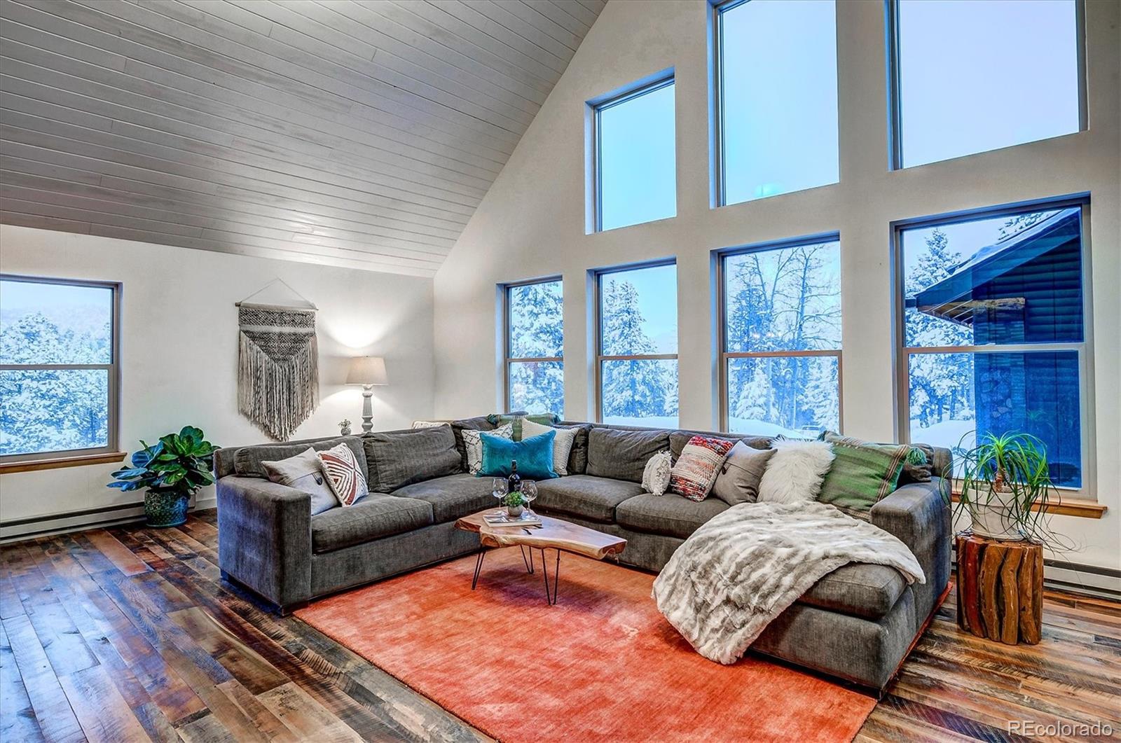 9055 Eagle Cliff Road Conifer, CO 80433 - Photo 6 of 39 a living room with furniture and windows