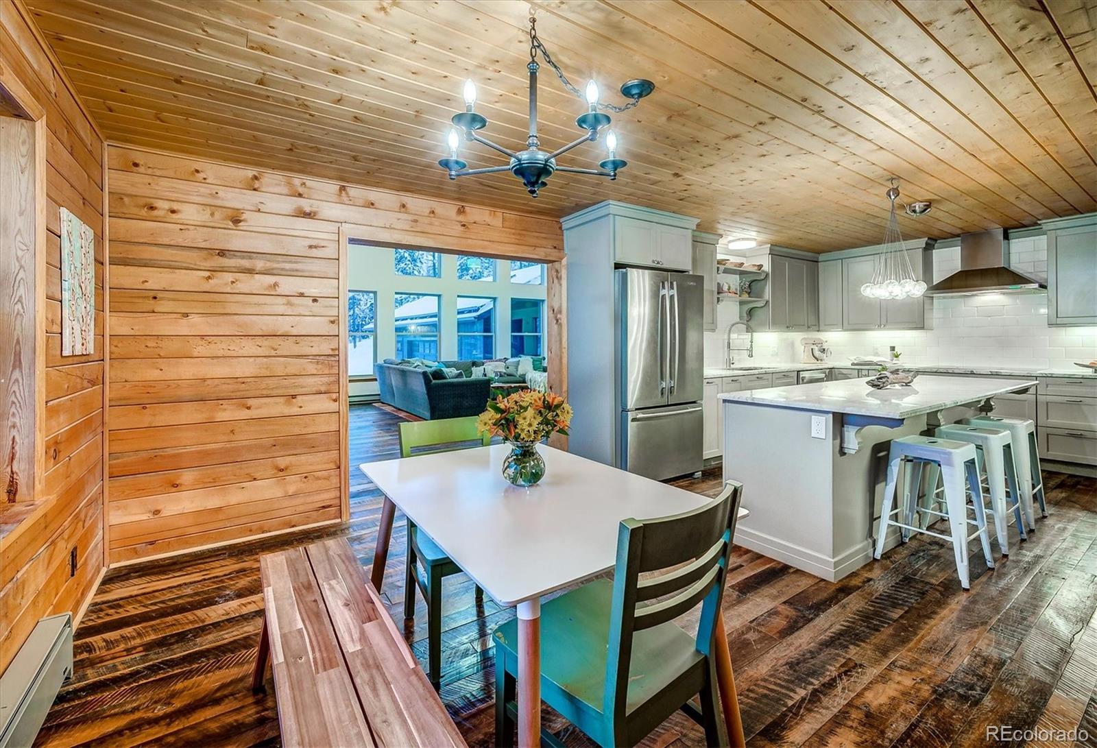 9055 Eagle Cliff Road Conifer, CO 80433 - Photo 8 of 39 a view of a dining room with furniture window and wooden floor