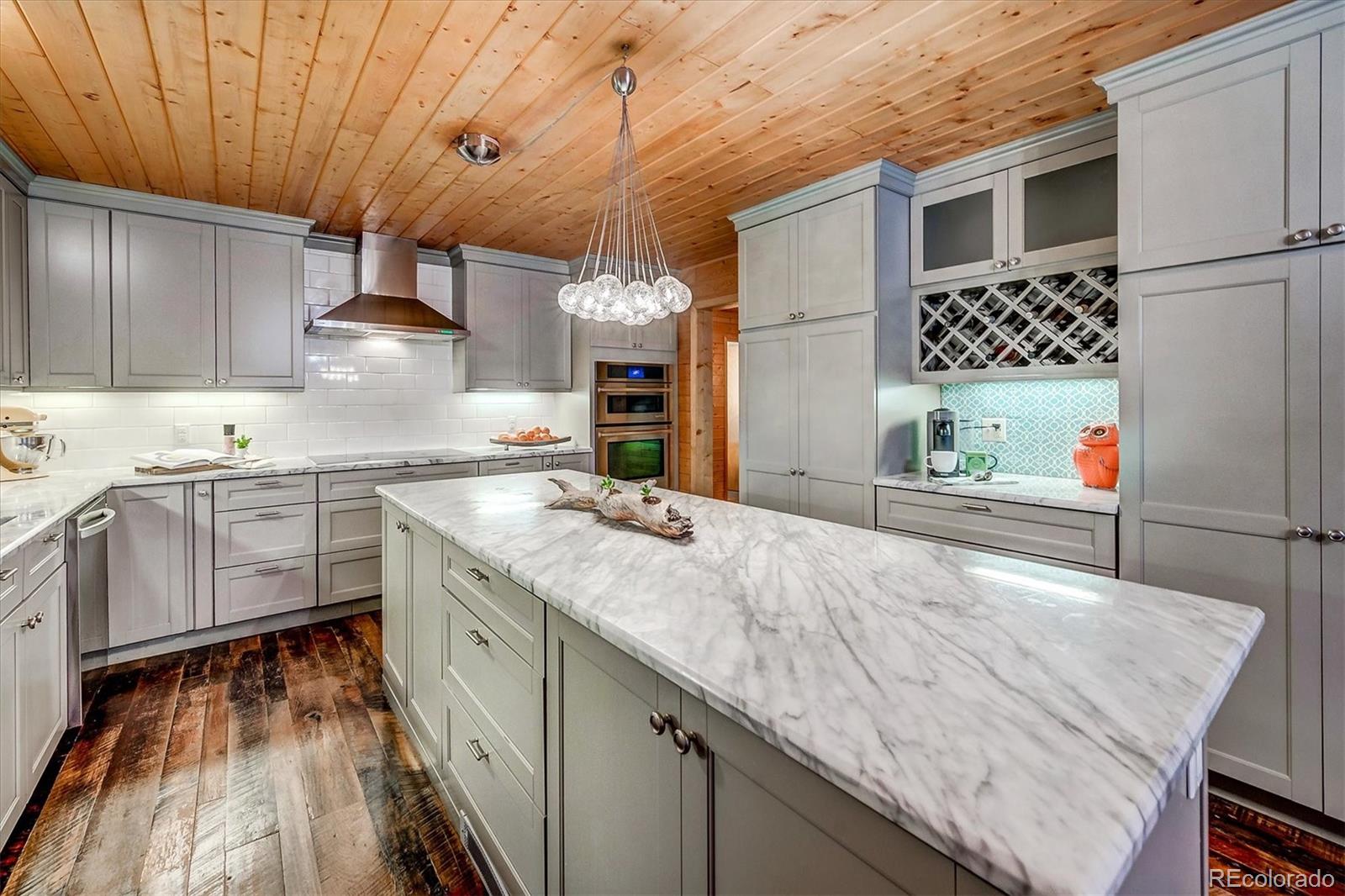 9055 Eagle Cliff Road Conifer, CO 80433 - Photo 10 of 39 a kitchen with a sink stove and cabinets
