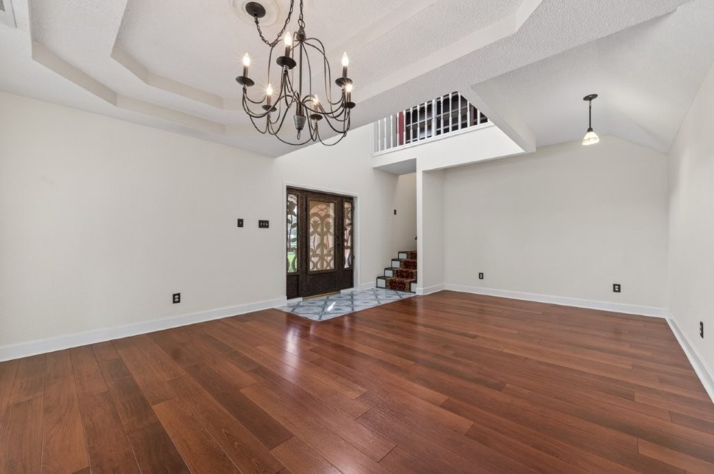 6610 Sprigg Street Fulshear, TX 77441 - Photo 11 of 49 a view of a room with wooden floor and ceiling fan