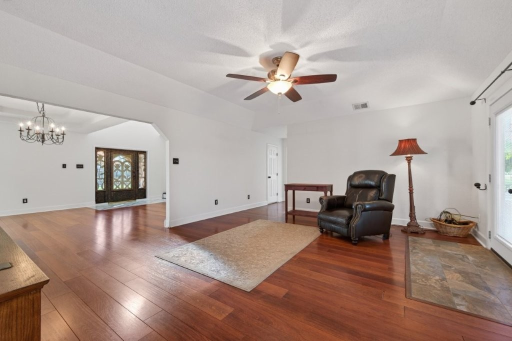 6610 Sprigg Street Fulshear, TX 77441 - Photo 12 of 49 a living room with furniture and wooden floor