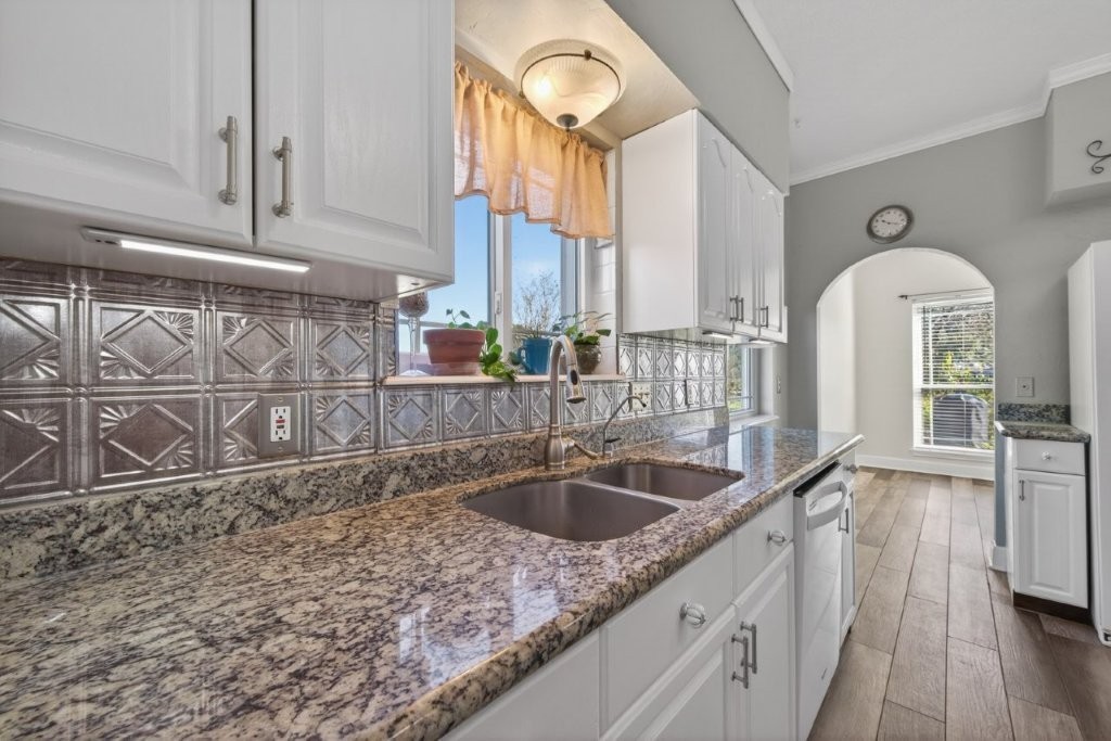 6610 Sprigg Street Fulshear, TX 77441 - Photo 19 of 49 a kitchen with granite countertop a sink and cabinets