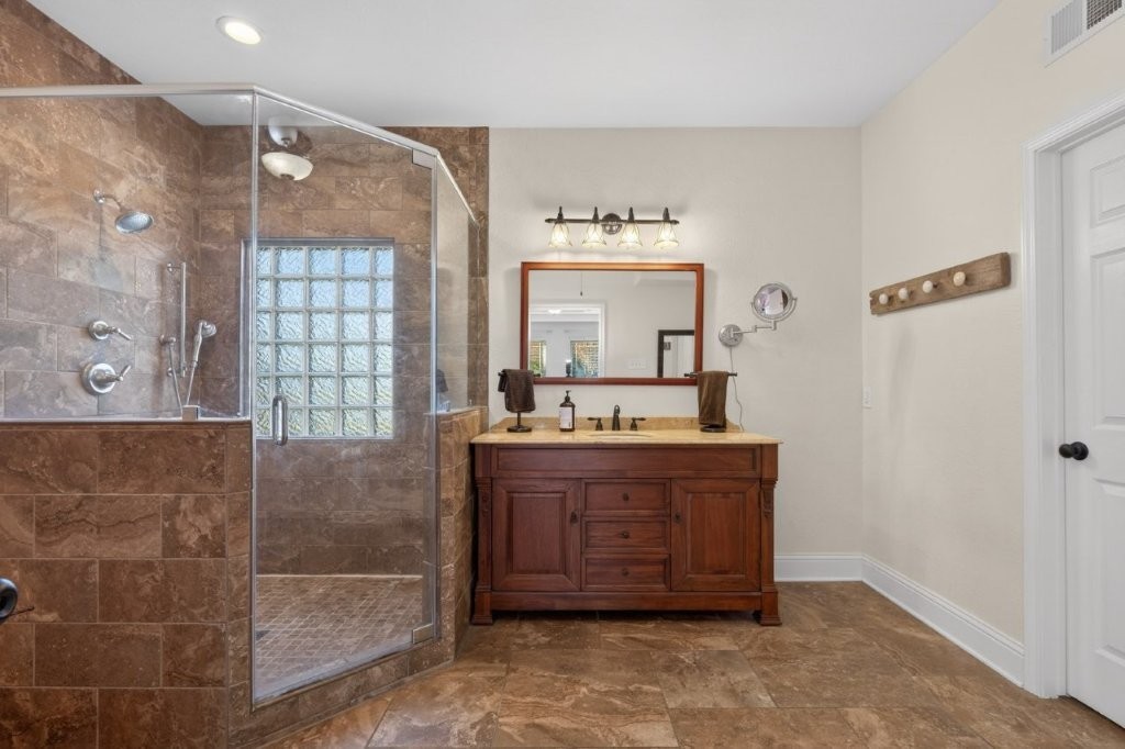 6610 Sprigg Street Fulshear, TX 77441 - Photo 24 of 49 a bathroom with a sink mirror and a bathtub