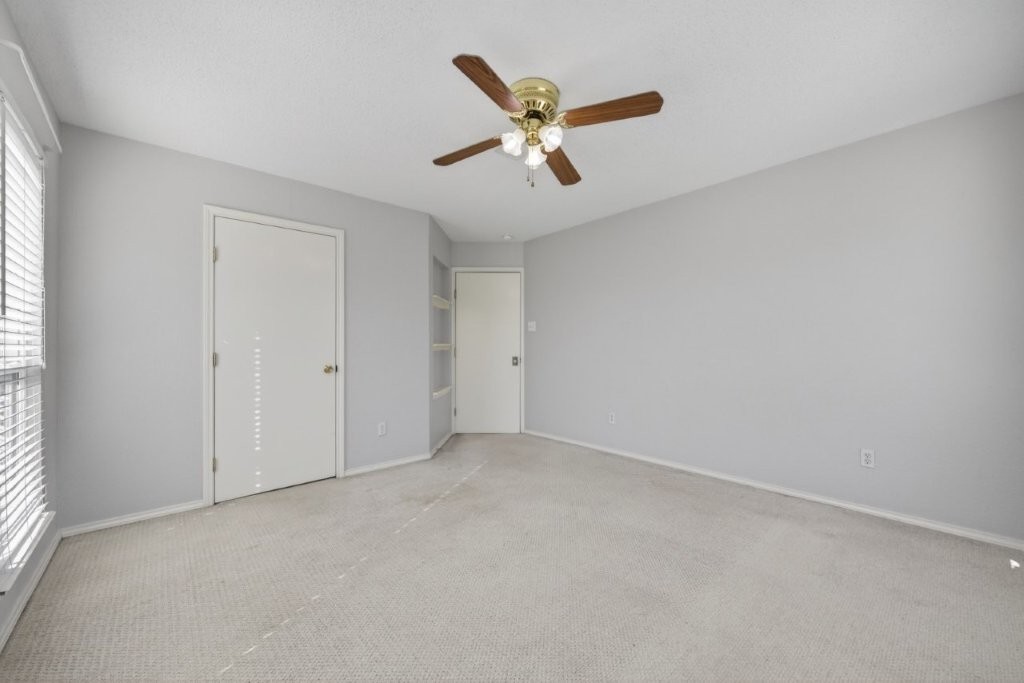 6610 Sprigg Street Fulshear, TX 77441 - Photo 29 of 49 an empty room with closet and windows