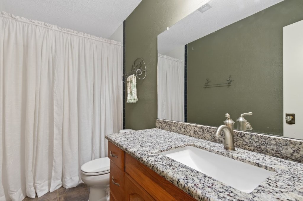 6610 Sprigg Street Fulshear, TX 77441 - Photo 31 of 49 a bathroom with a granite countertop sink and a mirror