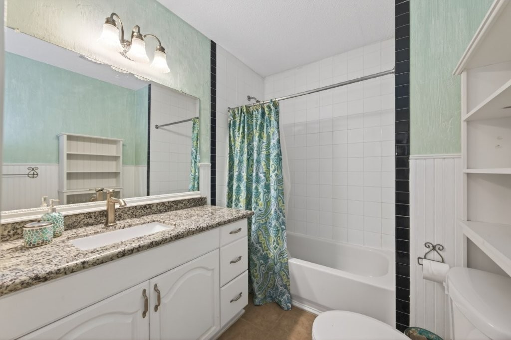 6610 Sprigg Street Fulshear, TX 77441 - Photo 35 of 49 a bathroom with a granite countertop sink toilet and shower