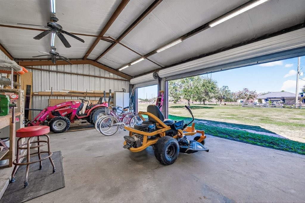 6610 Sprigg Street Fulshear, TX 77441 - Photo 46 of 49 a view of a garage with parked cars