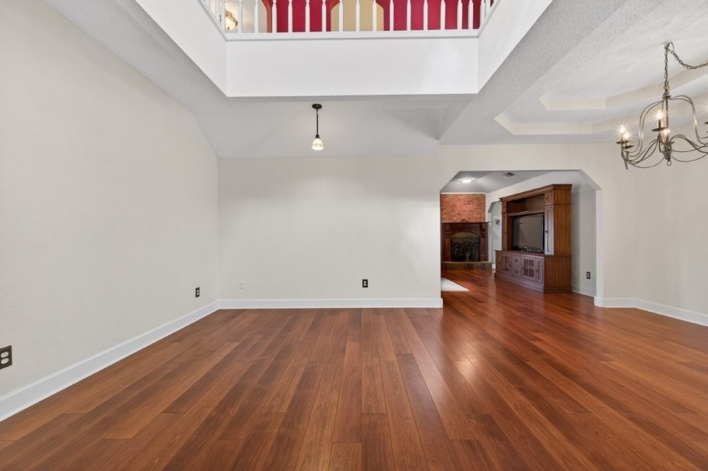 6610 Sprigg Street Fulshear, TX 77441 - Photo 8 of 49 wooden floor in an empty room with a window