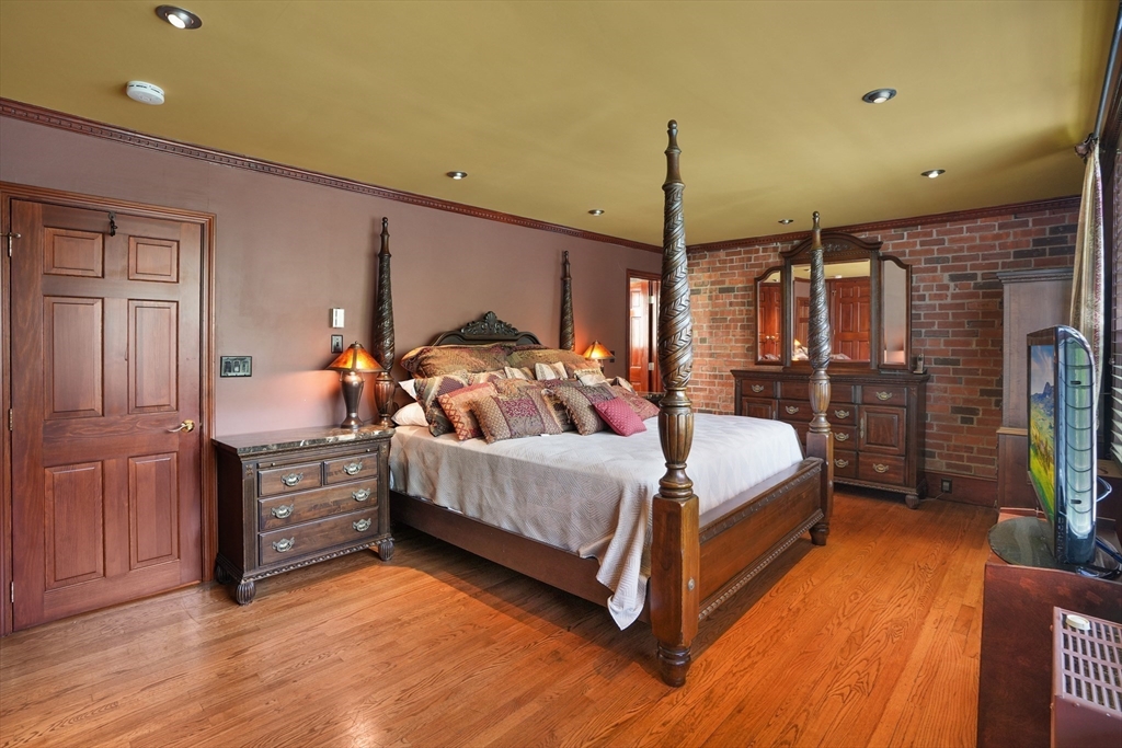 131 Perkins Street, Unit 131 Boston, MA 02130 - Photo 9 of 21 a bedroom with a bed a flat screen tv and dresser