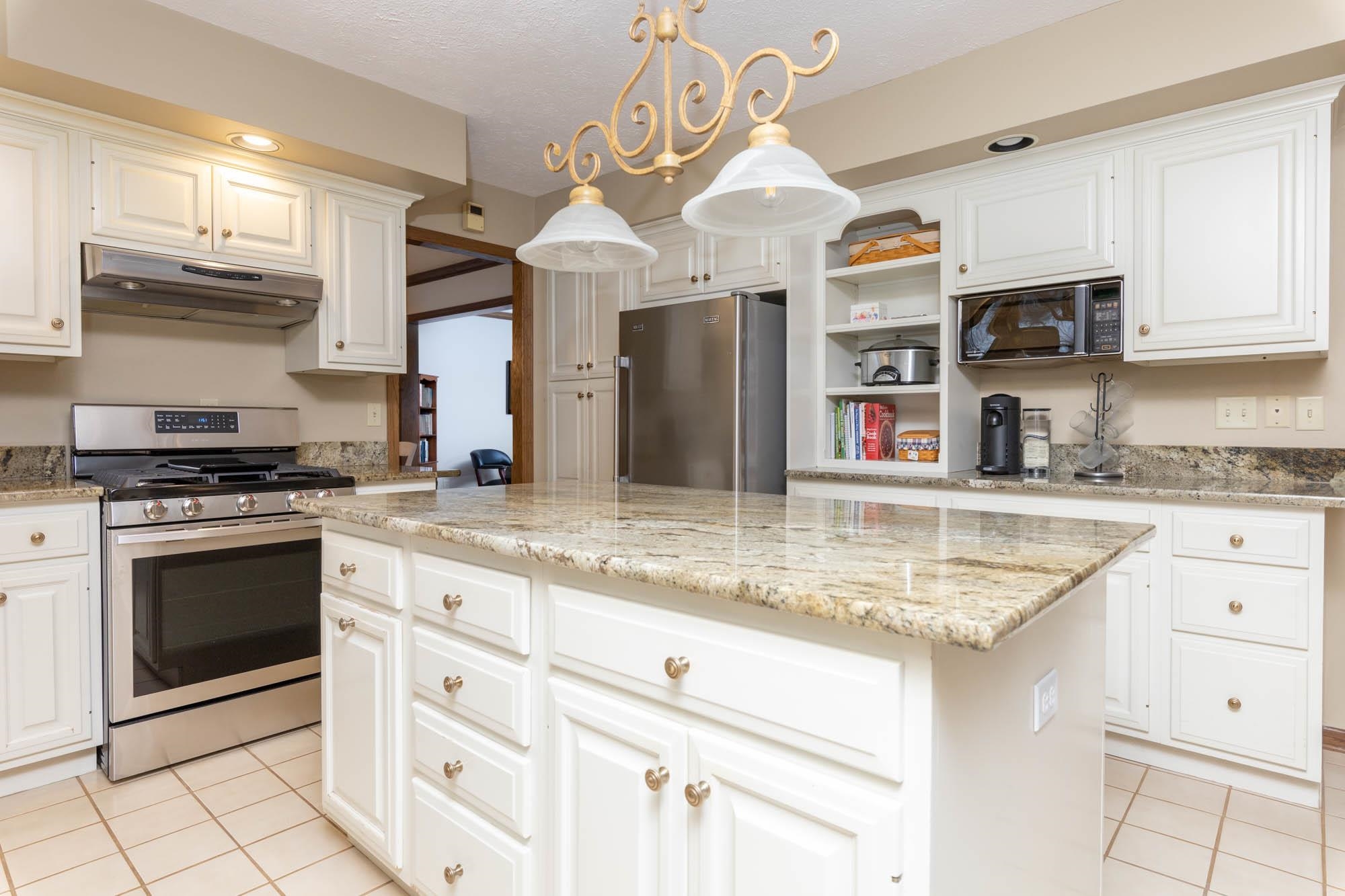 7113 Sentinel Road Rockford, IL 61107 - Photo 12 of 38 a kitchen with stainless steel appliances granite countertop a sink a stove and cabinets
