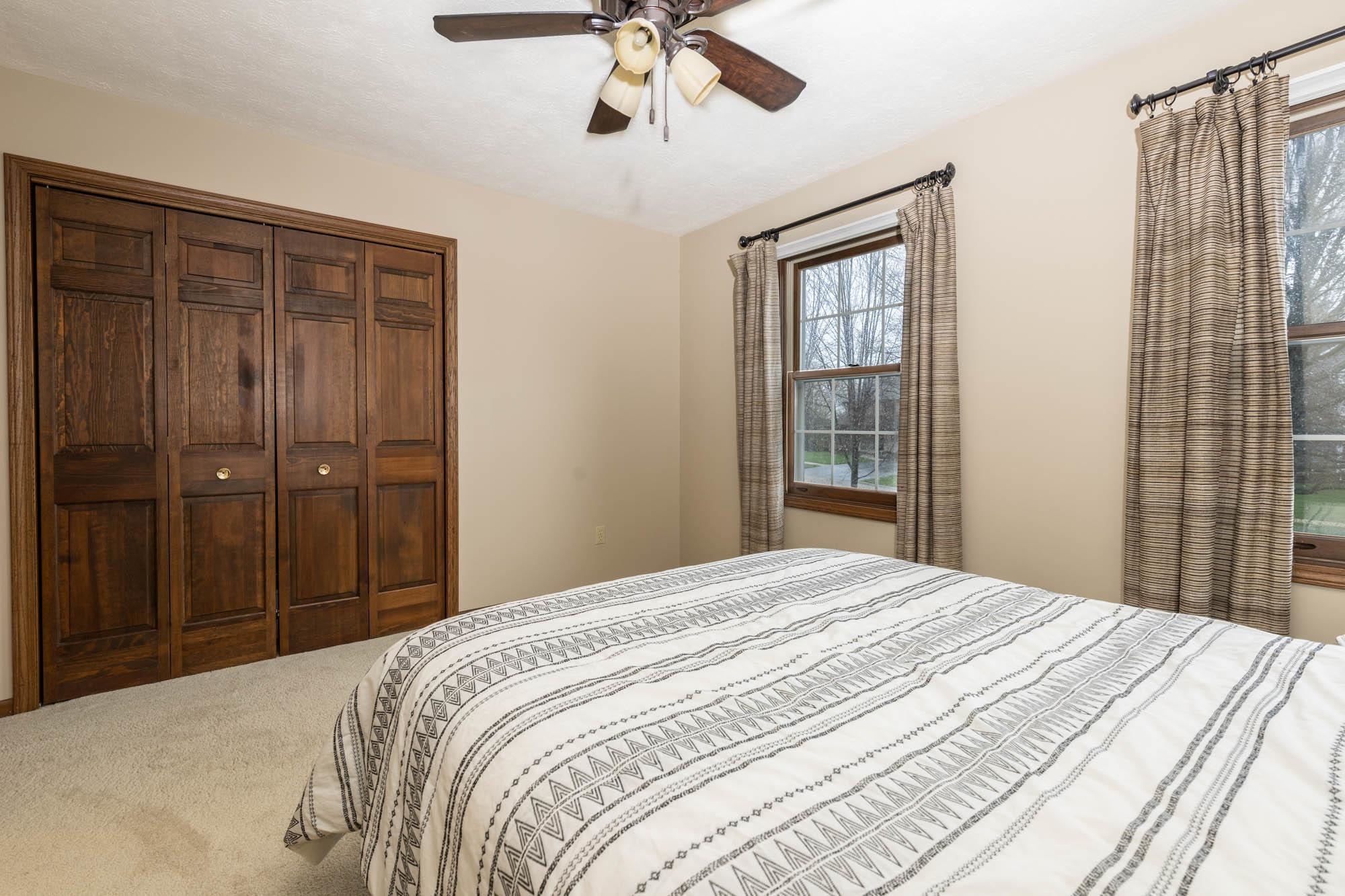 7113 Sentinel Road Rockford, IL 61107 - Photo 25 of 38 a bedroom with a bed and a chandelier