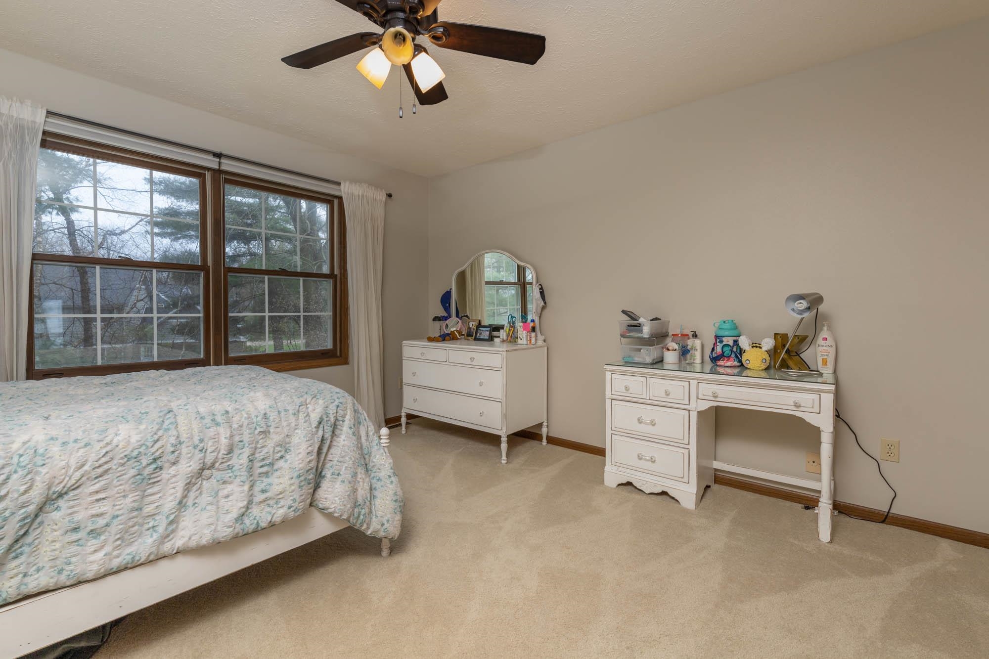 7113 Sentinel Road Rockford, IL 61107 - Photo 28 of 38 a bedroom with a bed and a chandelier