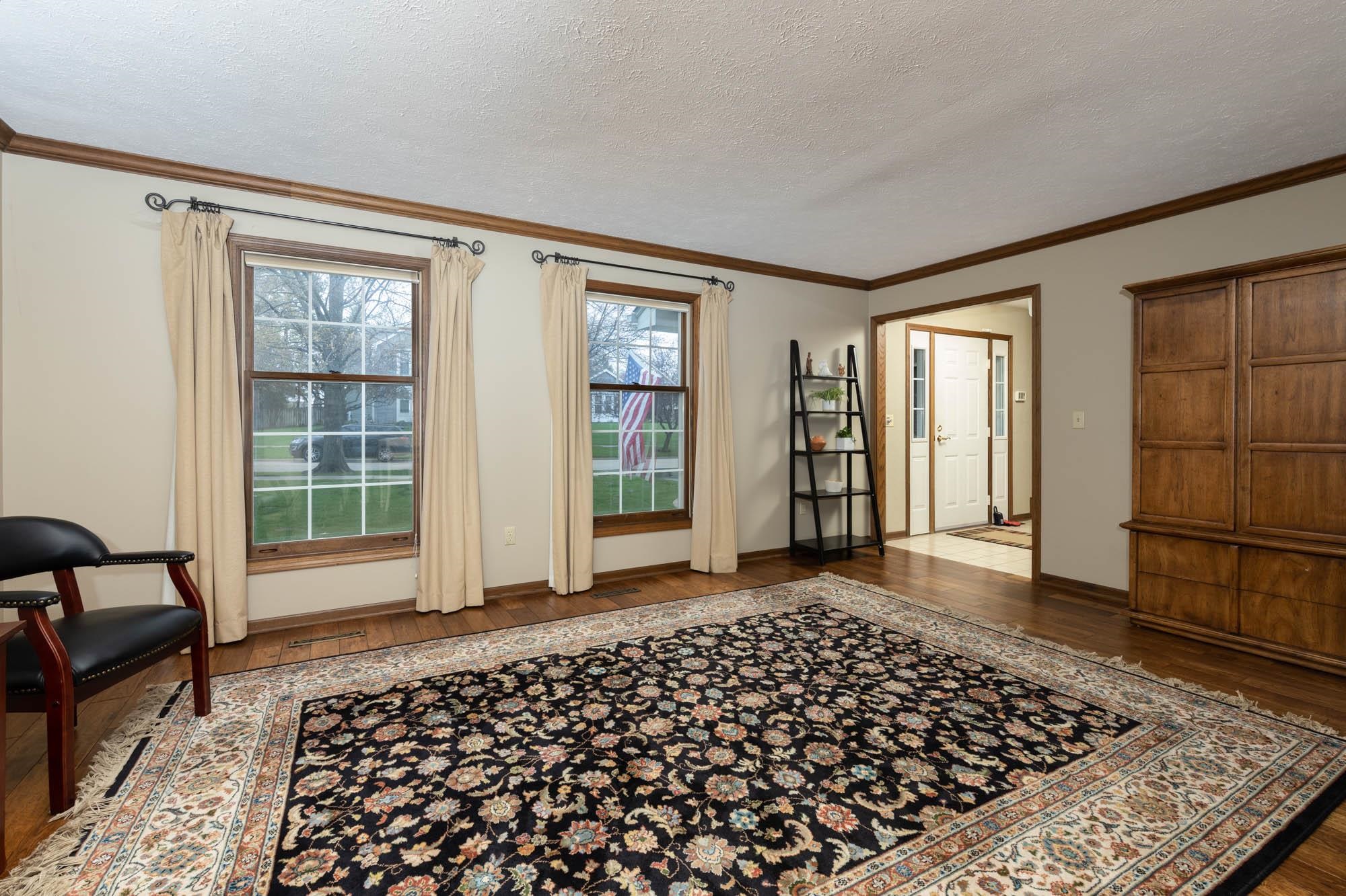 7113 Sentinel Road Rockford, IL 61107 - Photo 5 of 38 a view of a livingroom with wooden floor and a couch
