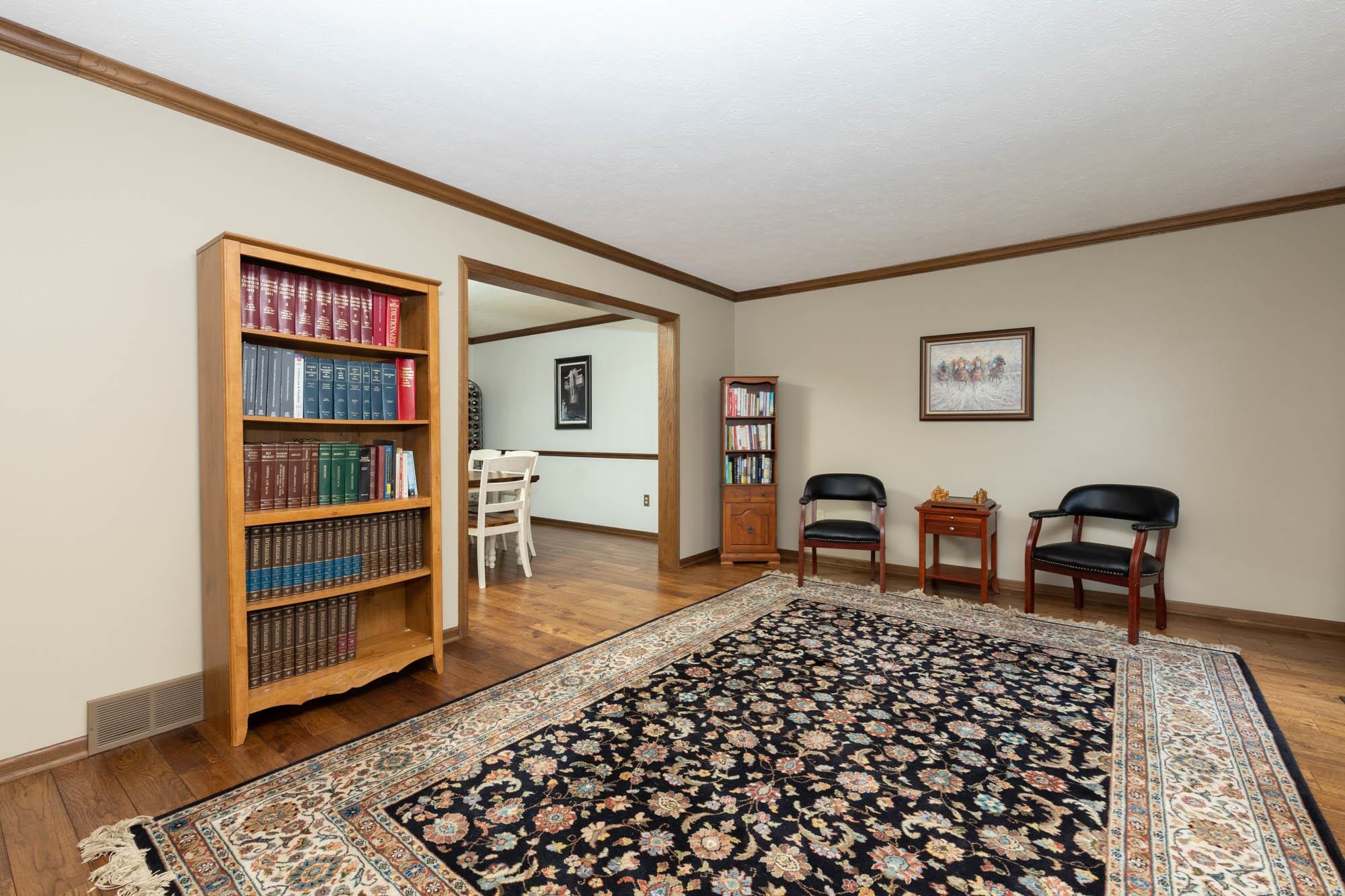 7113 Sentinel Road Rockford, IL 61107 - Photo 6 of 38 a living room with a couch and a dresser with wooden floor