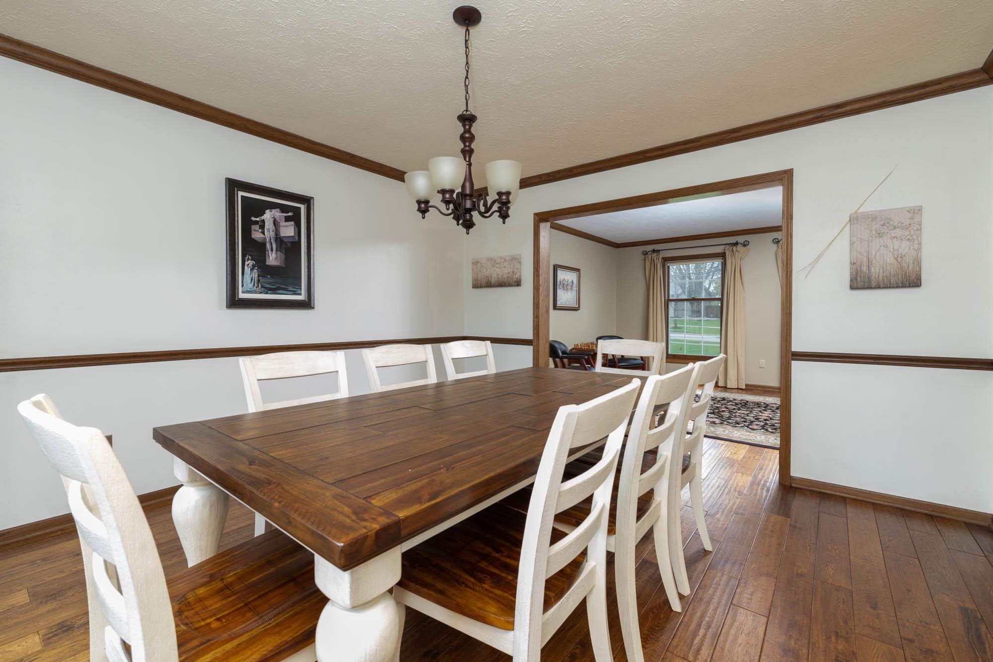 7113 Sentinel Road Rockford, IL 61107 - Photo 8 of 38 a view of a dining room with furniture wooden floor and a chandelier