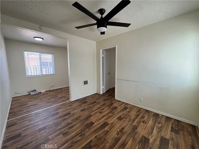 a view of a livingroom with a hardwood floor and a ceiling fan