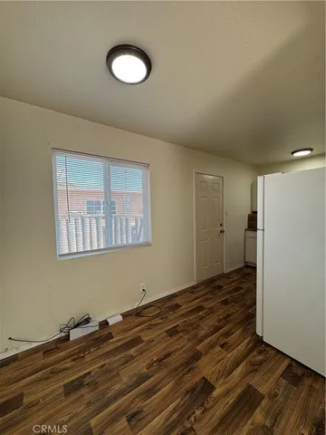 a view of a room with wooden floor