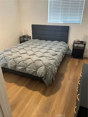 a bed sitting in a bedroom next to a window