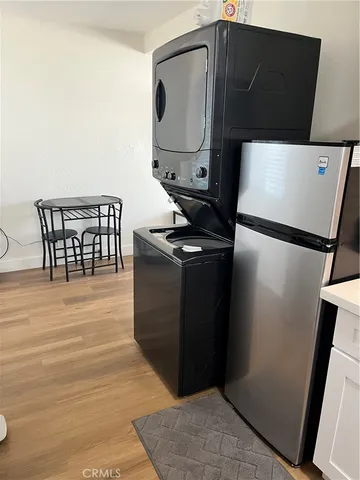 a view of a refrigerator and wooden floor