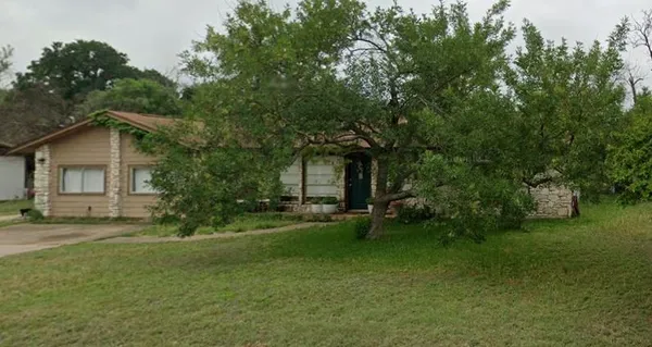 a view of a house with a yard and sitting area