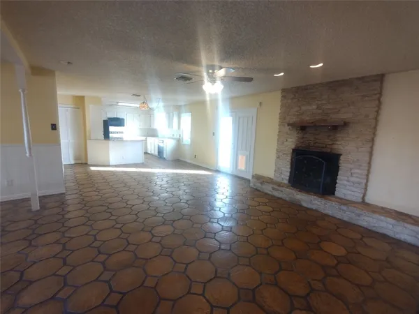a view of a kitchen with a sink and a fireplace