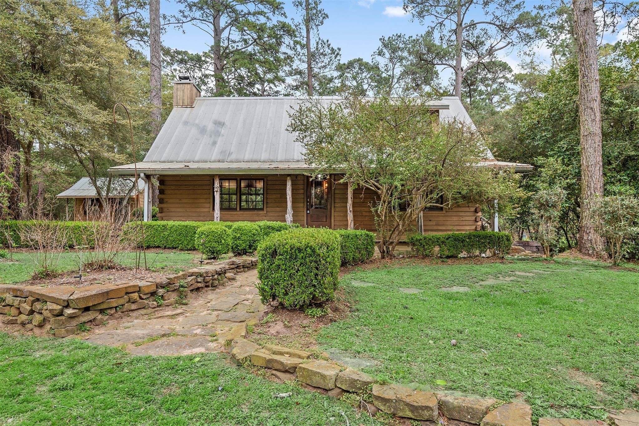 a front view of a house with a garden