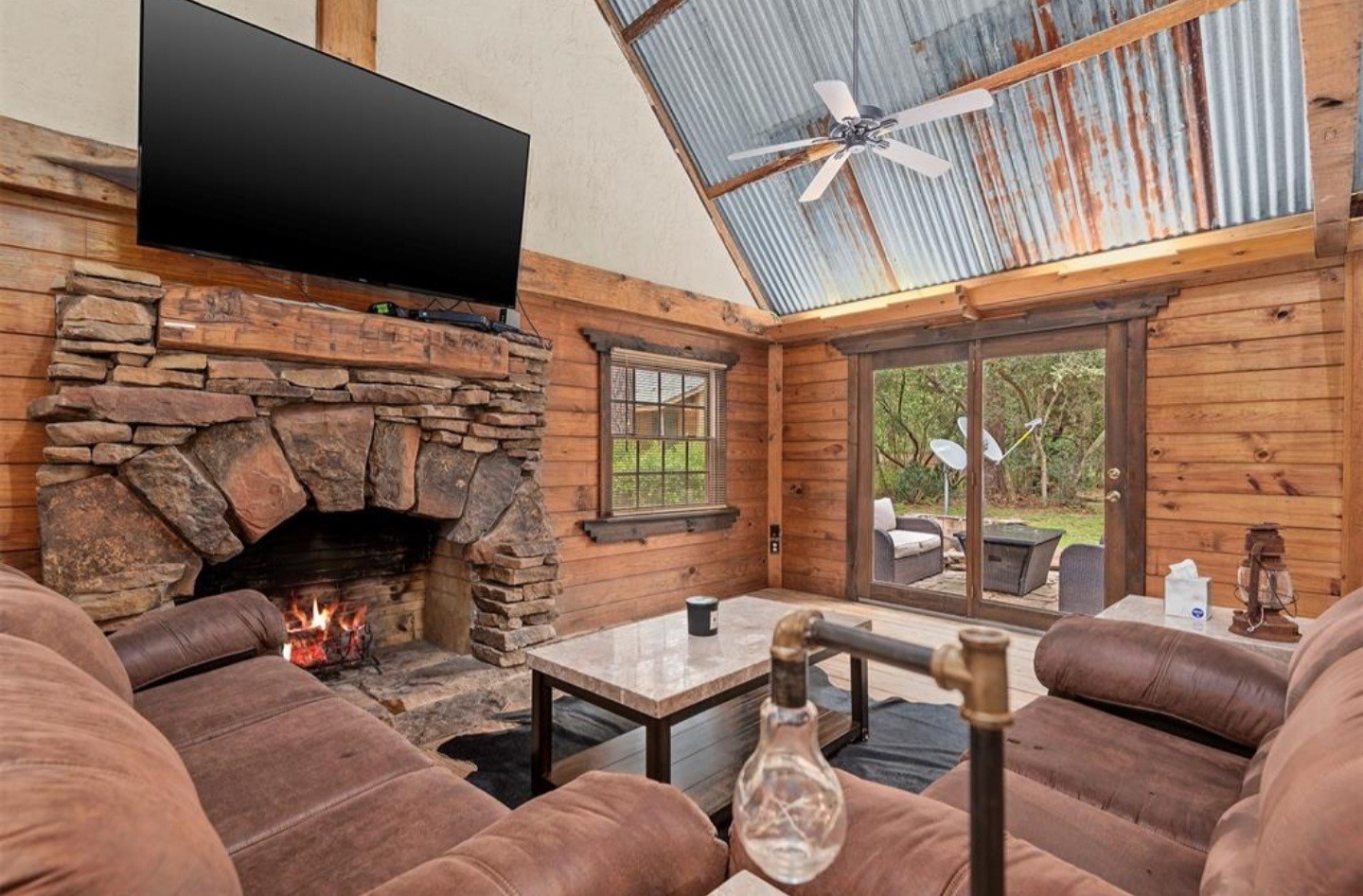 23207 Decker Prairie-Rosehill Road Magnolia, TX 77355 - Photo 22 of 29 a living room with furniture a flat screen tv and a fireplace