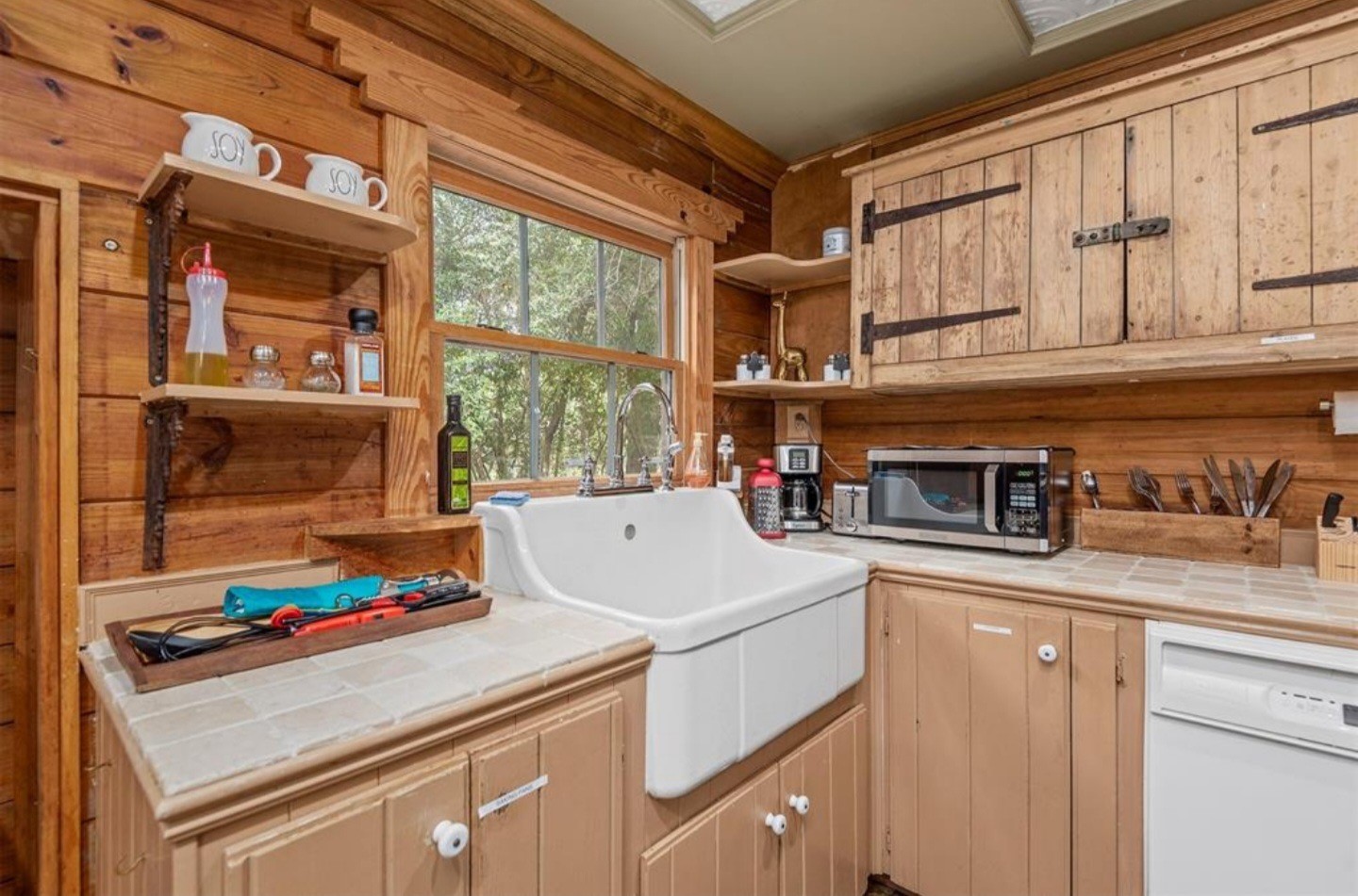 23207 Decker Prairie-Rosehill Road Magnolia, TX 77355 - Photo 7 of 29 a kitchen with a stove and a white cabinets