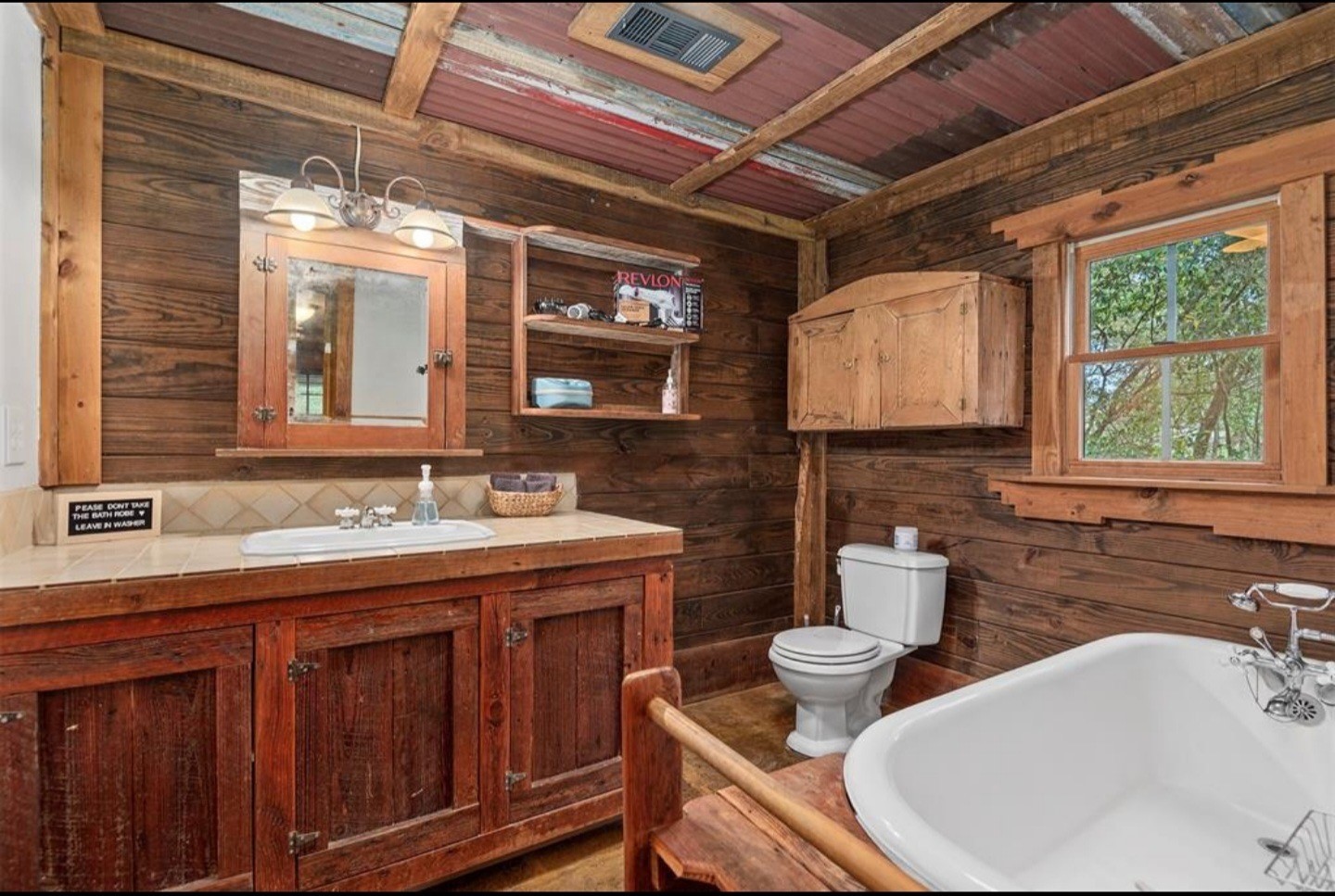 23207 Decker Prairie-Rosehill Road Magnolia, TX 77355 - Photo 10 of 29 a bathroom with a double vanity sink toilet and a mirror