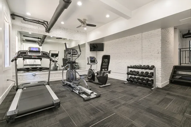 a room with gym equipment and a large window