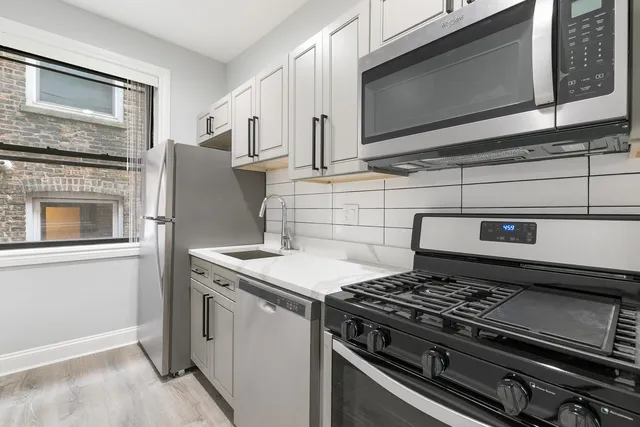 a stove top oven sitting inside of a kitchen