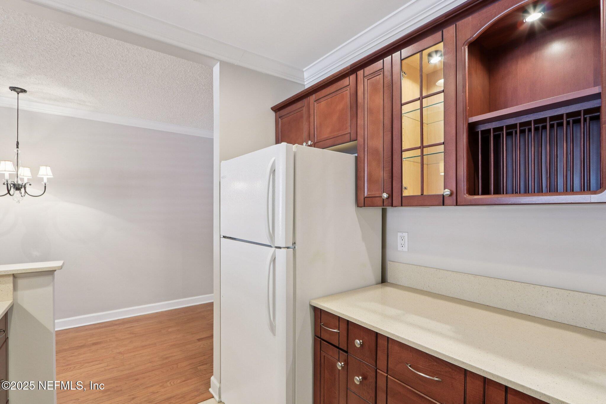 1810 Sevilla Boulevard West, Unit 307 Atlantic Beach, FL 32233 - Photo 12 of 28 a white refrigerator freezer sitting inside of a kitchen