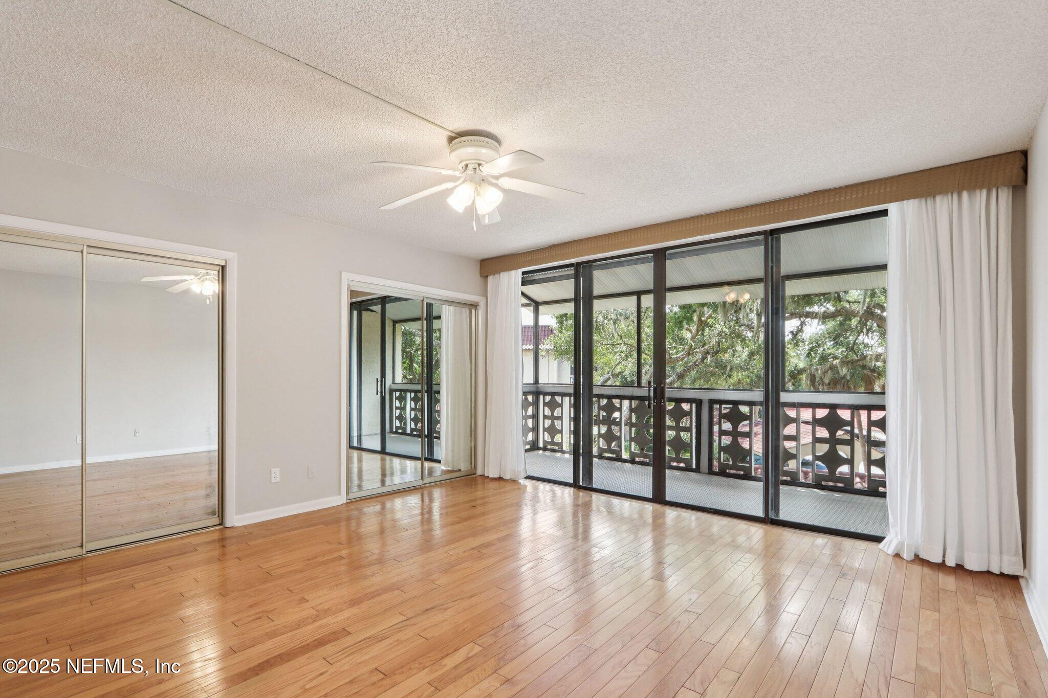 1810 Sevilla Boulevard West, Unit 307 Atlantic Beach, FL 32233 - Photo 18 of 28 wooden floor in an empty room with a window