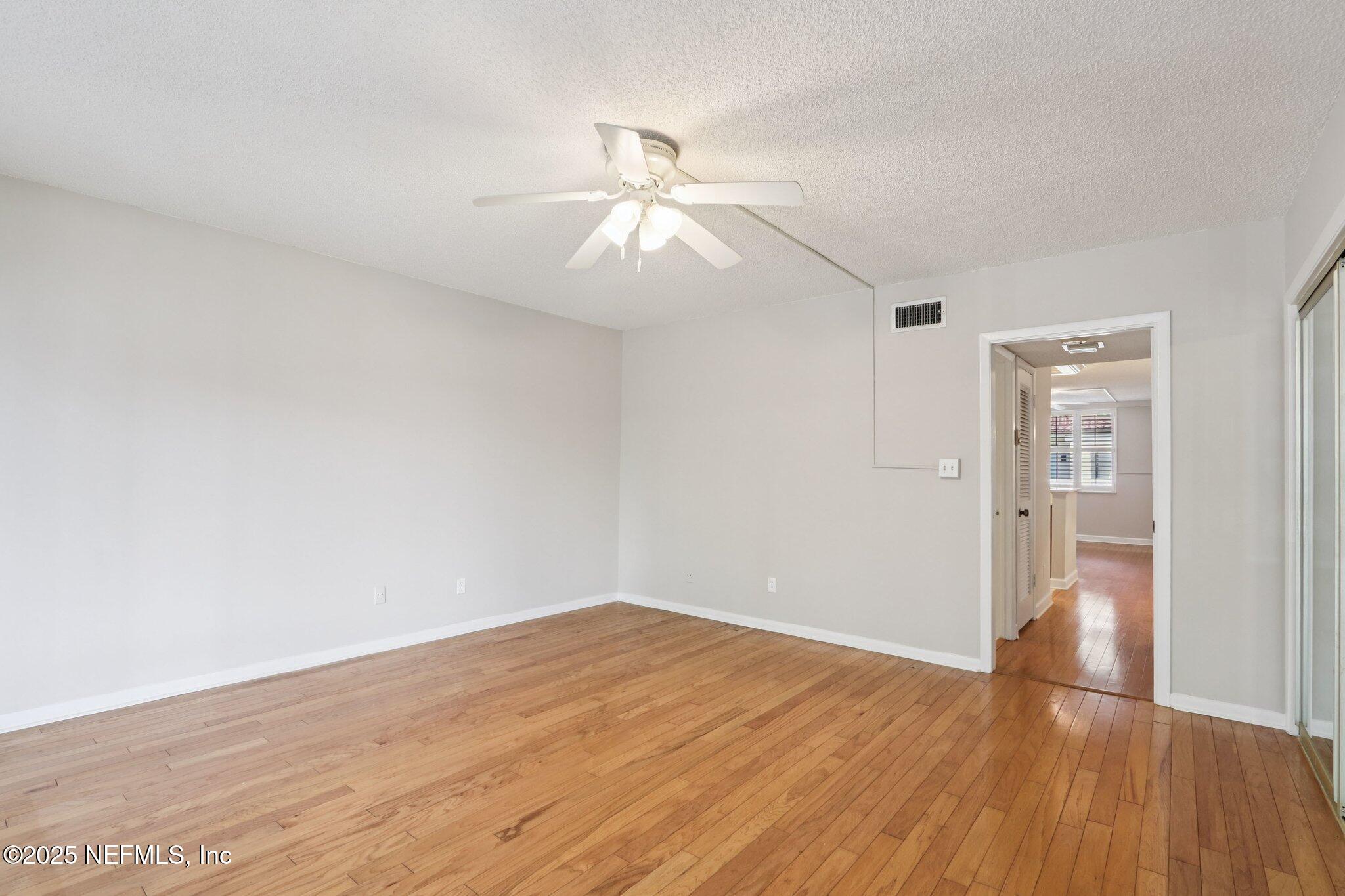 1810 Sevilla Boulevard West, Unit 307 Atlantic Beach, FL 32233 - Photo 19 of 28 a view of empty room with wooden floor
