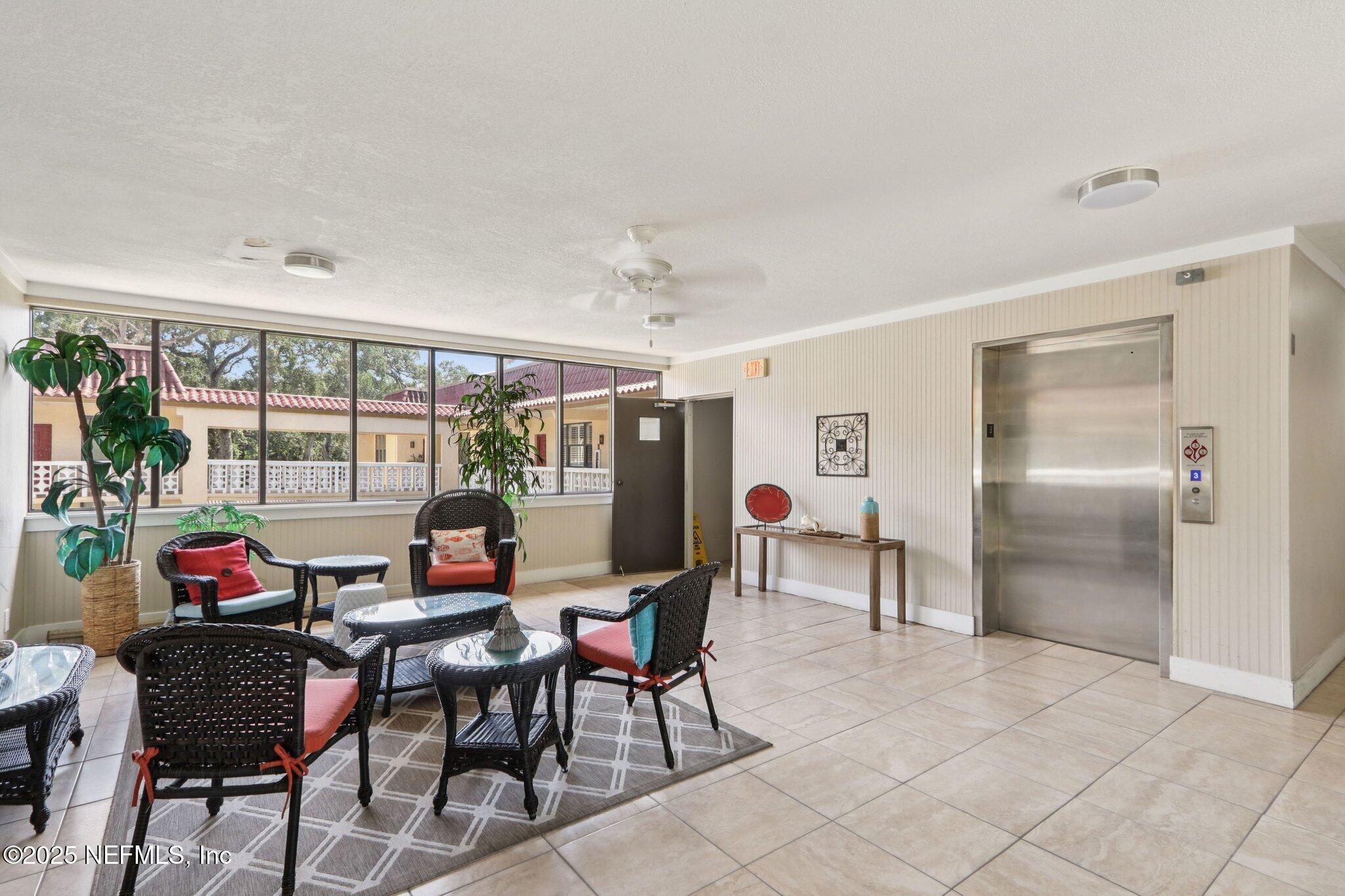 1810 Sevilla Boulevard West, Unit 307 Atlantic Beach, FL 32233 - Photo 24 of 28 a dining room with furniture and a floor to ceiling window