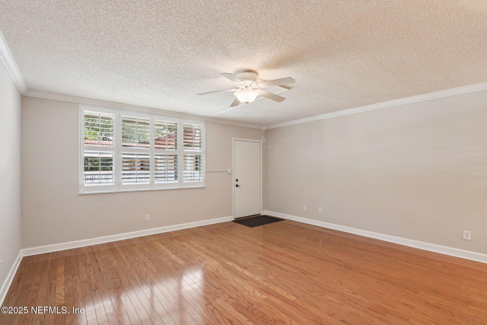 1810 Sevilla Boulevard West, Unit 307 Atlantic Beach, FL 32233 - Photo 6 of 28 a view of a big room with wooden floor and windows