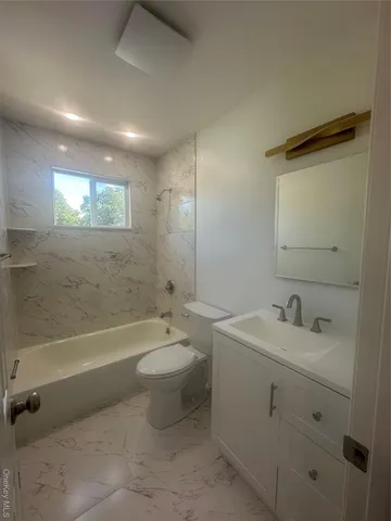 a bathroom with a sink a toilet and bathtub